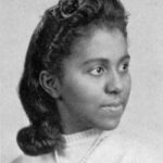 Black & white portrait of a young Black woman in a white shirt