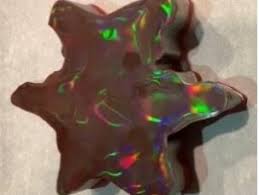 a snowflake-shaped chocolate with iridescent color highlights