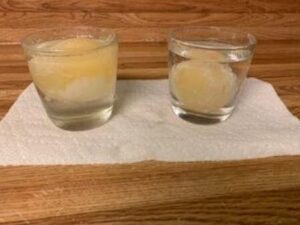 two glasses with eggs floating in liquid