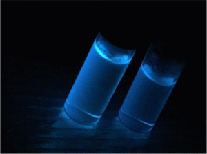 two vials of bright blue glowing liquid